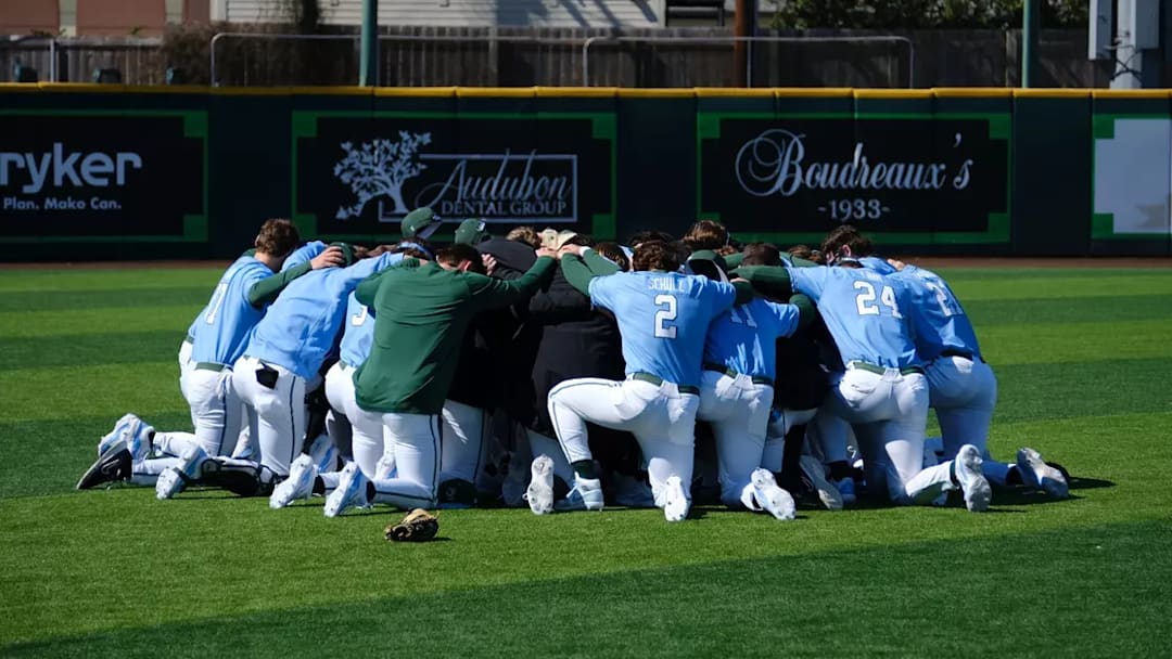 The Tulane Green Wave baseball program gathers in prayer moments before it takes the diamond.