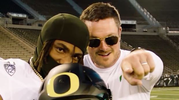 Oregon Ducks recruiting target Dallas Wilson and coach Dan Lanning in Autzen Stadium.