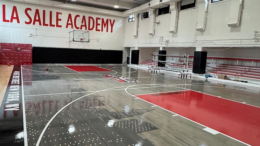 Featuring a New York City skyline and La Salle Cardinal branding, the new basketball court design was created by Christopher Arena (Senior VP & Head of On-Court & Brand Partnerships at the NBA).