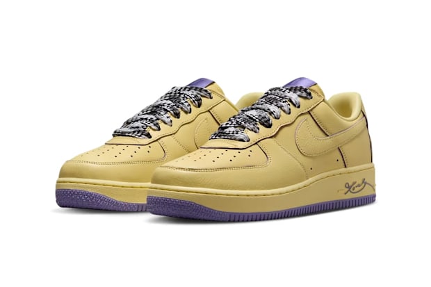 Side view of yellow Nike Air Force 1 sneakers.