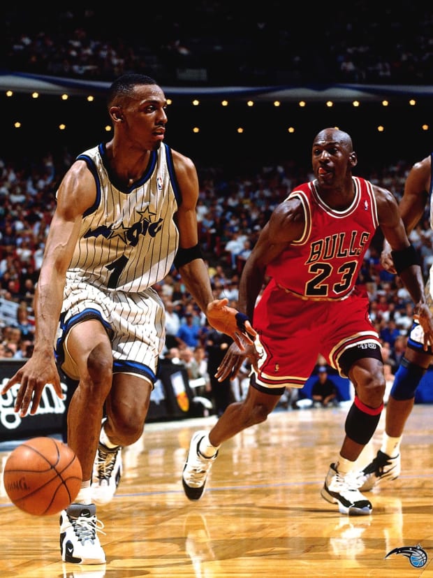 Penny Hardaway dribbles away from Michael Jordan.