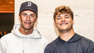 Tom Brady and JJ McCarthy pose for the camera.
