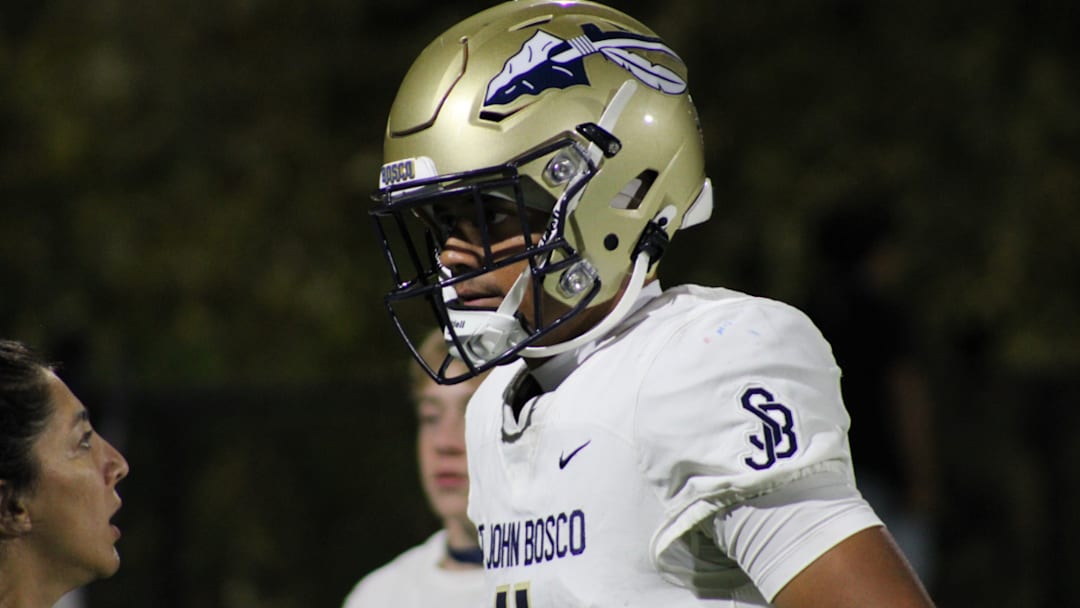 Matai Fuiava of St. John Bosco speaking to the team trainer.