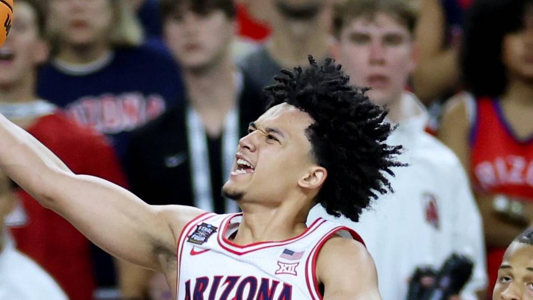 Apr 4, 2026; Indianapolis, IN, USA; Arizona Wildcats guard Brayden Burries (5) goes to the basket against Michigan Wolverines forward Morez Johnson Jr. (21) in the second half during a semifinal of the Final Four of the men's 2026 NCAA Tournament at Lucas Oil Stadium. Mandatory Credit: Trevor Ruszkowski-Imagn Images