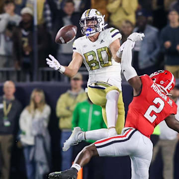 Nov 25, 2023; Atlanta, Georgia, USA; Georgia Tech Yellow Jackets tight end Brett Seither (80) reaches for a ball in front of Georgia Bulldogs linebacker Smael Mondon Jr. (2) in the second half at Bobby Dodd Stadium at Hyundai Field. Mandatory Credit: Brett Davis-Imagn Images