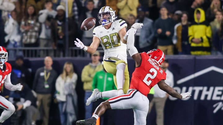 Nov 25, 2023; Atlanta, Georgia, USA; Georgia Tech Yellow Jackets tight end Brett Seither (80) reaches for a ball in front of Georgia Bulldogs linebacker Smael Mondon Jr. (2) in the second half at Bobby Dodd Stadium at Hyundai Field. Mandatory Credit: Brett Davis-USA TODAY Sports