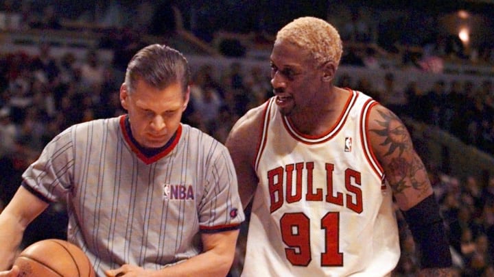 Dennis Rodman shares his thoughts with an official during a March 1998 game.