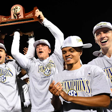 The Arkansas Razorbacks hoist the team trophy after winning the 2025 SEC Men's Track & Field Championship in Lexington, Ky.