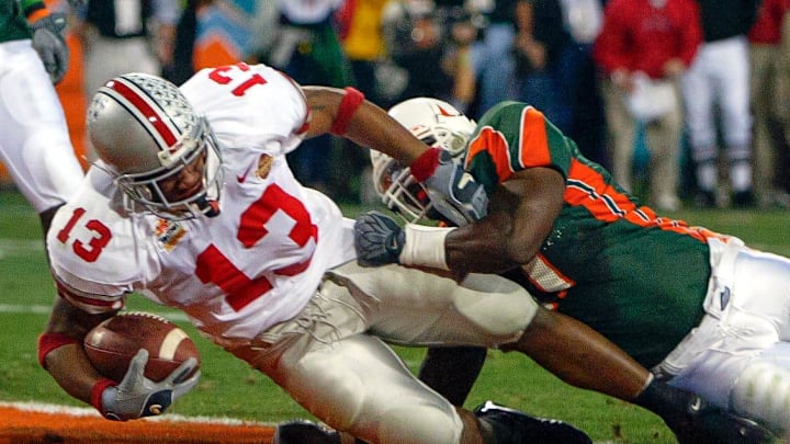 Ohio State's Maurice Clarett (13) slips past a Miami tackle for a touchdown in the second quarter of the National Football Championships at the Sun Devil Stadium in Tempe, Arizona, January 3, 2003.