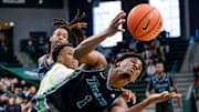 Tulane Green Wave forward Kaleb Banks (1) zeros in on a rebound against the South Florida Bulls during the first half of an NCAA men's basketball game at Devin Fieldhouse in New Orleans, Louisiana.