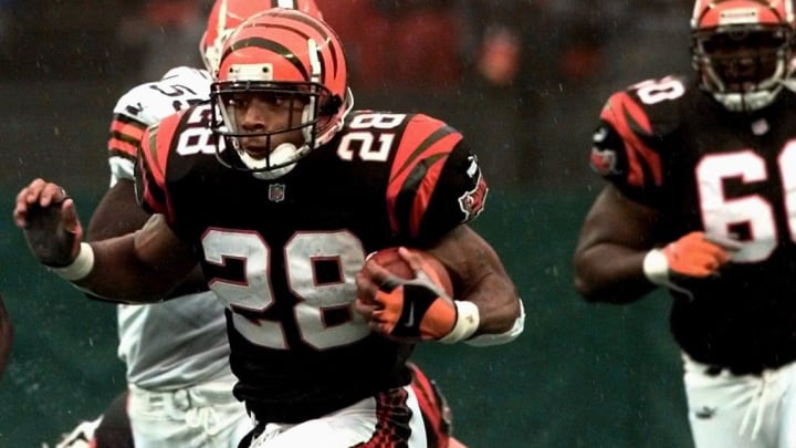 Former Husky Corey Dillon of the Cincinnati Bengals breaks a tackle against the Cleveland Browns in their 1999 game.