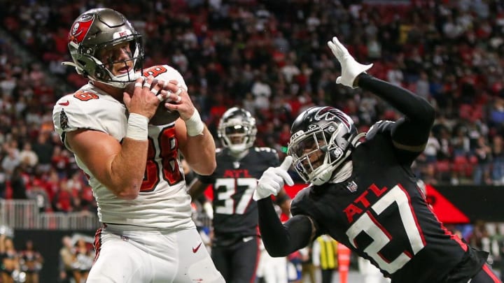 Dec 10, 2023; Atlanta, Georgia, USA; Tampa Bay Buccaneers tight end Cade Otton (88) catches a touchdown pass over Atlanta Falcons safety Richie Grant (27) in the second half at Mercedes-Benz Stadium. Mandatory Credit: Brett Davis-USA TODAY Sports