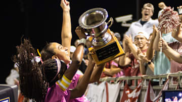 Crimson Tide players celebrate with the trophy and their fans at the Alabama Soccer Stadium after winning the 2025 Iron Bowl of Soccer.