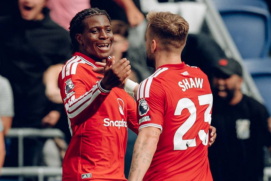 Patrick Dorgu (left) greeting Luke Shaw.