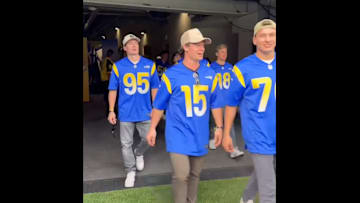 Members of the Colorado Avalanche walk the field before a Los Angeles Rams game.