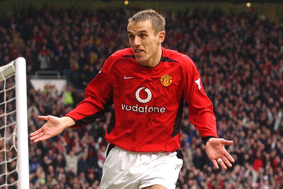Phil Neville shrugging in celebration.