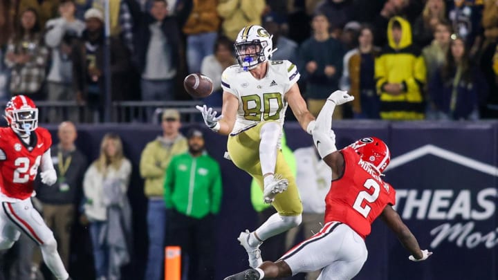 Nov 25, 2023; Atlanta, Georgia, USA; Georgia Tech Yellow Jackets tight end Brett Seither (80) reaches for a ball in front of Georgia Bulldogs linebacker Smael Mondon Jr. (2) in the second half at Bobby Dodd Stadium at Hyundai Field. Mandatory Credit: Brett Davis-USA TODAY Sports