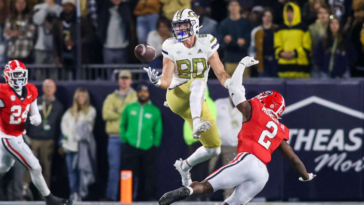 Nov 25, 2023; Atlanta, Georgia, USA; Georgia Tech Yellow Jackets tight end Brett Seither (80) reaches for a ball in front of Georgia Bulldogs linebacker Smael Mondon Jr. (2) in the second half at Bobby Dodd Stadium at Hyundai Field. Mandatory Credit: Brett Davis-USA TODAY Sports