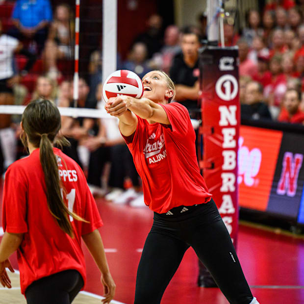 Jordan Larson passes the ball over the net. 