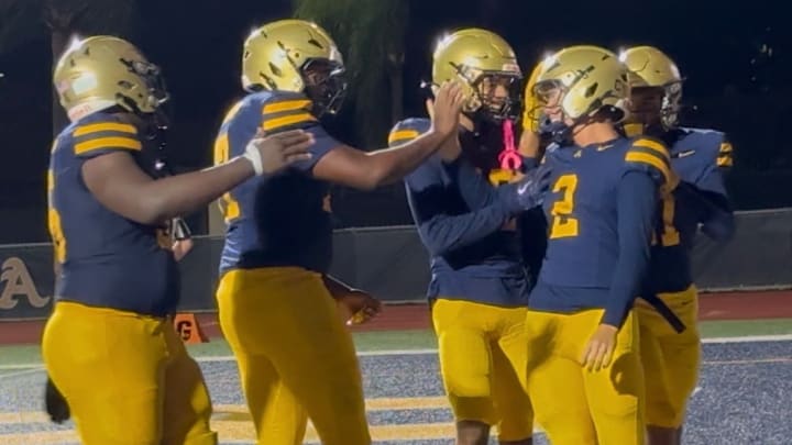 Andrew Indorf (2) of St. Thomas Aquinas scores his second touchdown in the Raiders' 44-6 win against Monarch.