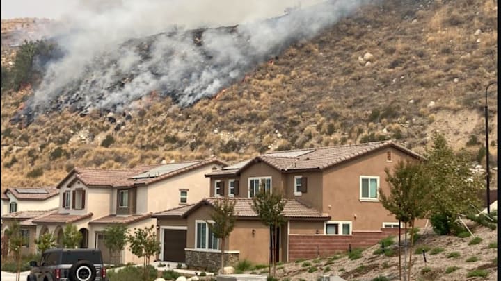 The Line Fire burns on Saturday, Sept. 7 near homes in the Mediterra housing development off Greenspot Road, in Highland. The fire had grown to 7,122 acress as of Saturday afternoon.