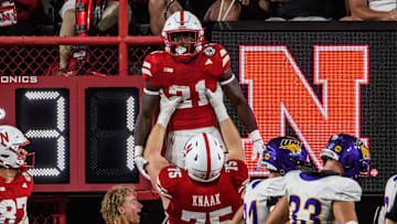 Tyler Knaak lifts Emmett Johnson after his 36-yard touchdown run. 