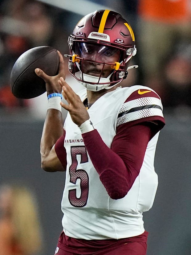 Quarterback Jayden Daniels (5) throws a pass in an NFL Week 3 game between the Cincinnati Bengals and Washington Commanders.