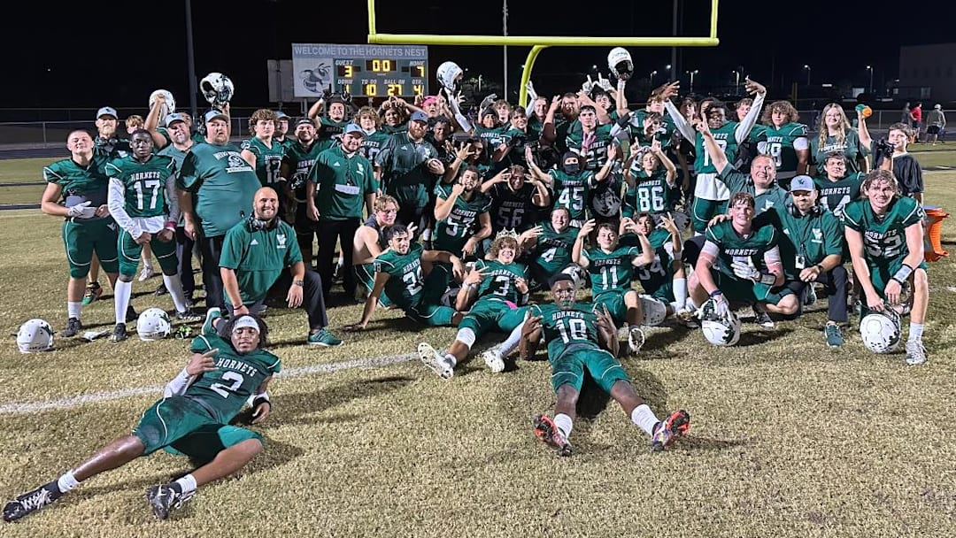 The Weeki Wachee football team poses in front of the scoreboard after defeating county-rival Hernando for the first time on Oct. 25, 2024.