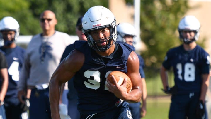 East Lansing's Jace Clarizio runs the ball during the opening day of high school football practice, Monday, Aug. 12, 2024, at East Lansing High School.