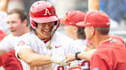 Arkansas Razorbacks shortstop Wehiwa Aloy is congratulated by coach Dave Van Horn after his home run last sea in the Fayetteville Regional of the NCAA Tournament.