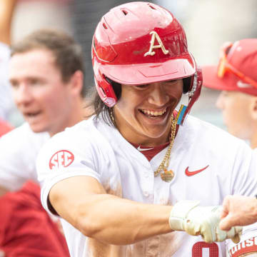 Arkansas Razorbacks shortstop Wehiwa Aloy is congratulated by coach Dave Van Horn after his home run last sea in the Fayetteville Regional of the NCAA Tournament.