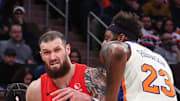 Toronto Raptors forward Sandro Mamukelashvili looks to drive past New York Knicks center Karl-Anthony Towns.