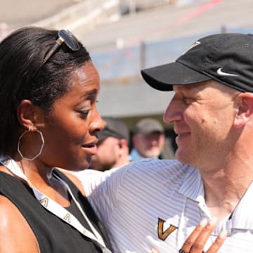 Candice Storey Lee and Clark Lea share a moment before a game.