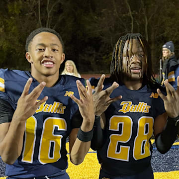 Bullis stars Quincy Wilson (16), Cameron Homer (28) and Connor Salmin (1), a Clemson commit, celebrate the Bulldogs' 13-12 win over Georgetown Prep, to capture a share of the the 2025 IAC Championship. Wilson had an interception and Salmin scored the go ahead touchdown. 