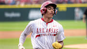 Arkansas shortstop Wehiwa Aloy rounds the bases after hitting a homer for the fourth straight game. The Razorbacks won the first game of the doubleheader 11-5. 