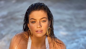 Sixtine was photographed by Derek Kettela in Belize. Swimsuit by Andi Bagus. Earrings by éliou.
