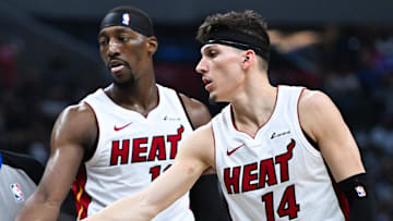 Jan 1, 2024; Los Angeles, California, USA; Miami Heat guard Kyle Lowry (7) celebrates with teammates center Bam Adebayo (13) and guard Tyler Herro (14) against the Los Angeles Clippers during the third quarter at Crypto.com Arena. Mandatory Credit: Jonathan Hui-Imagn Images