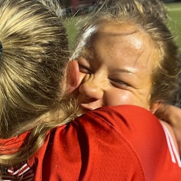 Maryvale Prep’s Lainey Minderlein (right) is hugged by teammate Cayden Reese after Friday’s IAAM A Conference lacrosse final. Minderlein, a junior reserve midfielder scored the final five goals for the Lions, who won their first title since 2002 with a 7-5 decision over Archbishop Spalding at USA Lacrosse’s Tierney Field in Sparks, Md.
