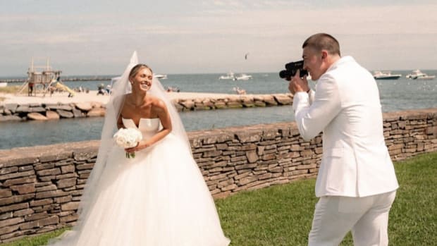 Former Oregon Duck Payton Pritchard snaps a photo of wife Emma MacDonald during their wedding in Massachusetts