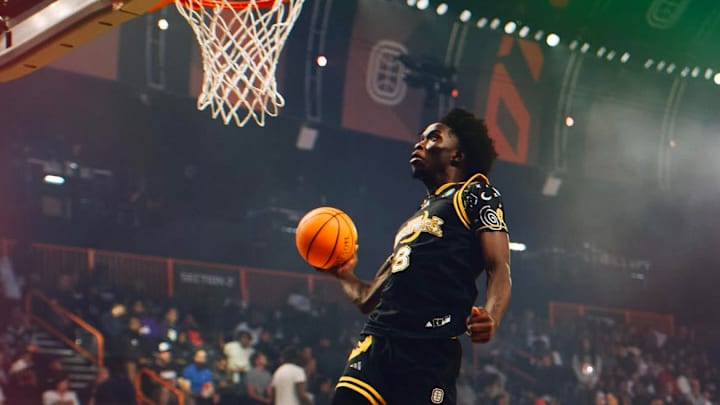 Abu Yarmah dunking the basketball at an OTE game with YNG Dreamerz