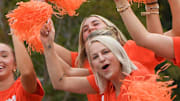 Grand Marshal Amy Smith, the Gymnastics team head coach, cheers and waves with athletes during Clemson University's 50th First Friday parade in Clemson, S.C. Friday, September 6, 2024. Clemson plays Appalachian State September 7.
