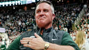 Michigan State's new football coach Pat Fitzgerald pats his heart at the crowd in attendance for the Spartans basketball game against Iowa on Tuesday, Dec. 2, 2025, at the Breslin Center in East Lansing.