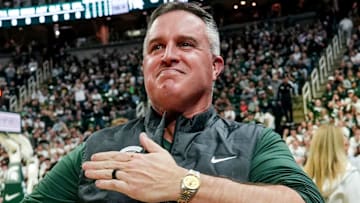 Michigan State's new football coach Pat Fitzgerald pats his heart at the crowd in attendance for the Spartans basketball game against Iowa on Tuesday, Dec. 2, 2025, at the Breslin Center in East Lansing.