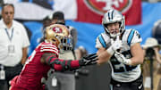 Oct 9, 2022; Charlotte, North Carolina, USA; Carolina Panthers running back Christian McCaffrey (22) tries to elude San Francisco 49ers defensive end Kemoko Turay (53) during the second half at Bank of America Stadium.