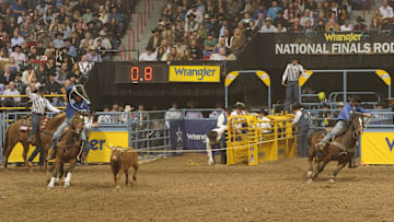 Spencer Mitchell, right, won a share of the 10th round at the 2011 Wrangler NFR in his final run with the late Broc Cresta. 