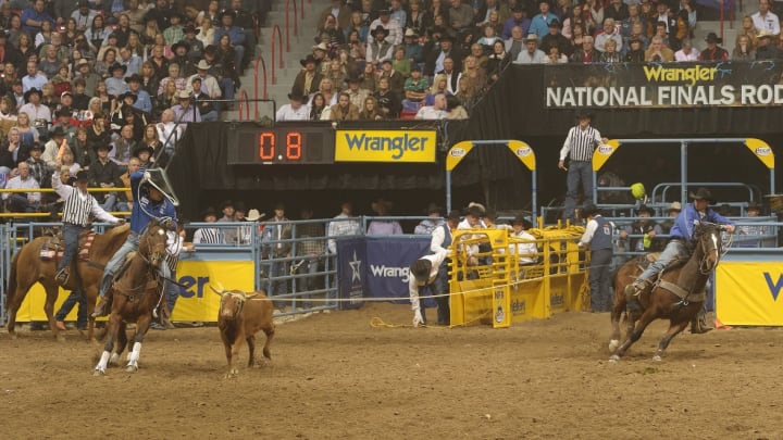 Spencer Mitchell, right, won a share of the 10th round at the 2011 Wrangler NFR in his final run with the late Broc Cresta. 