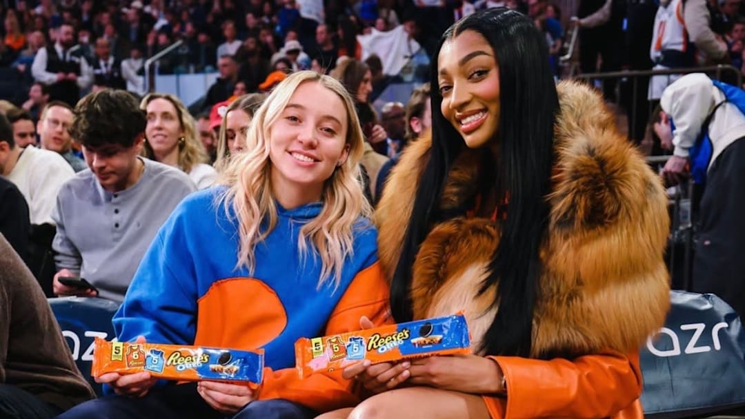 Angel Reese and Paige Bueckers sit curtsied at the New York Knicks game