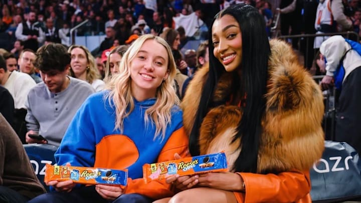 Angel Reese and Paige Bueckers sit curtsied at the New York Knicks game