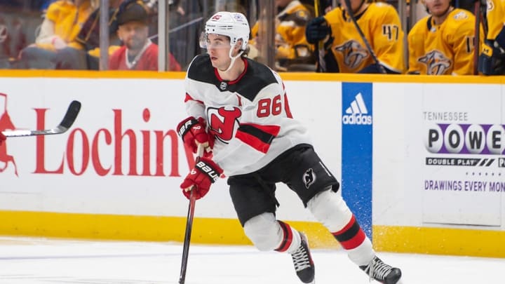 New Jersey Devils center Jack Hughes (86) skates with the puck against the Nashville Predators during the first period at Bridgestone Arena.