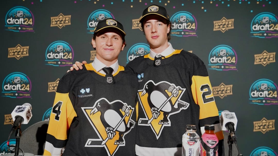 Pittsburgh Penguins' prospects Tanner Hower (left) and Harrison Brunicke (right) pose after being selected in the 2024 NHL Draft.